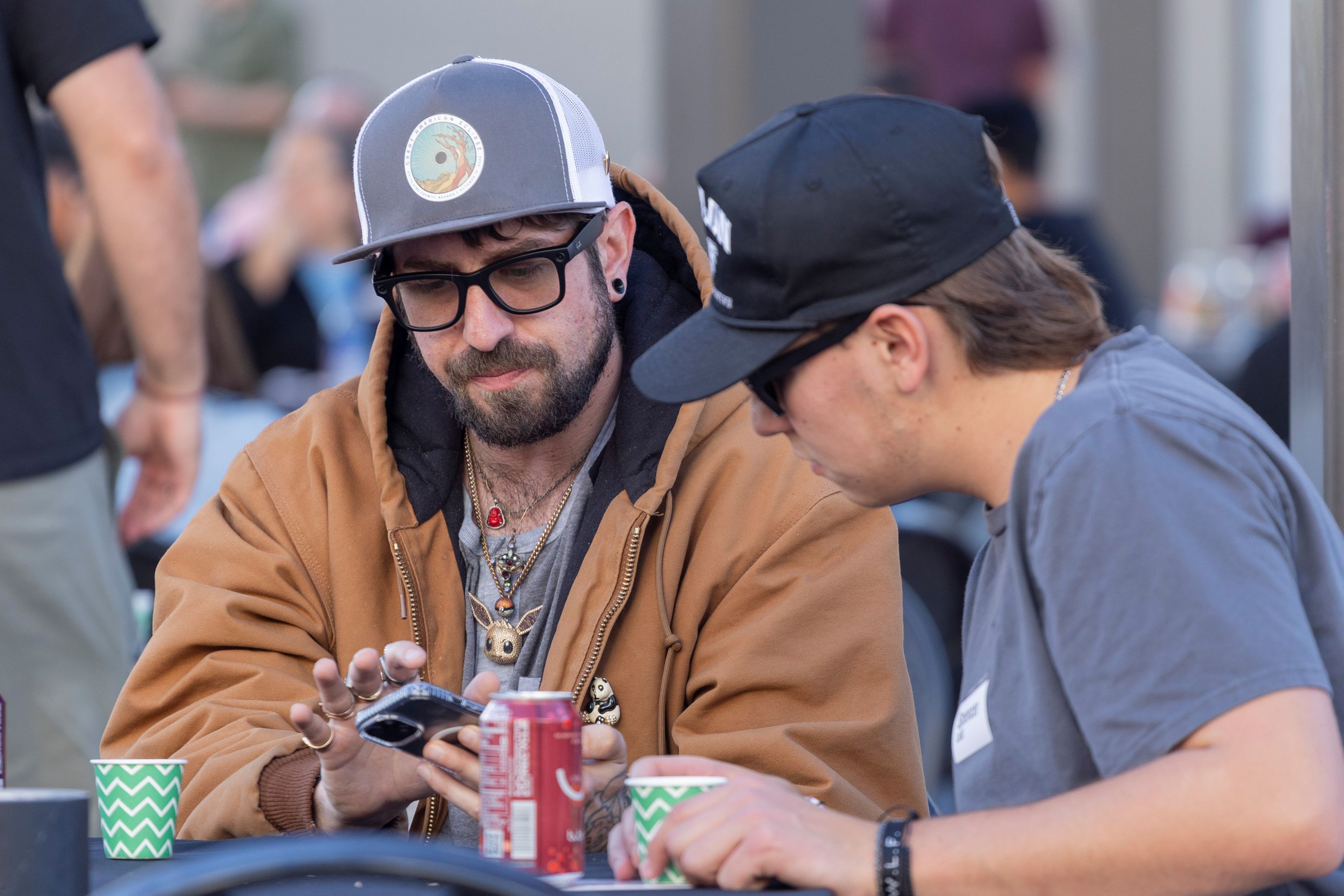 Two men looking down at a cell phone